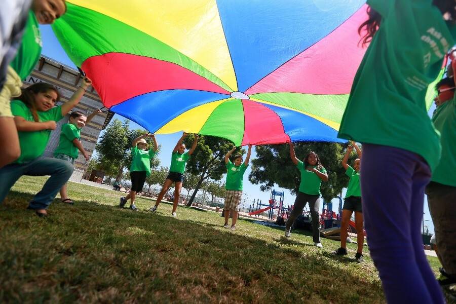 Children in the San Diego community play a fun parachute game as part of the Scripps community benefits program.