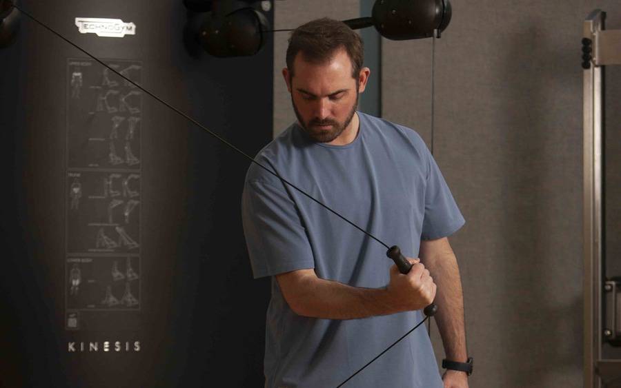 Heart failure survivor, Eric Roberts, works out with cable weights as part of his cardiac rehab plan at Scripps.