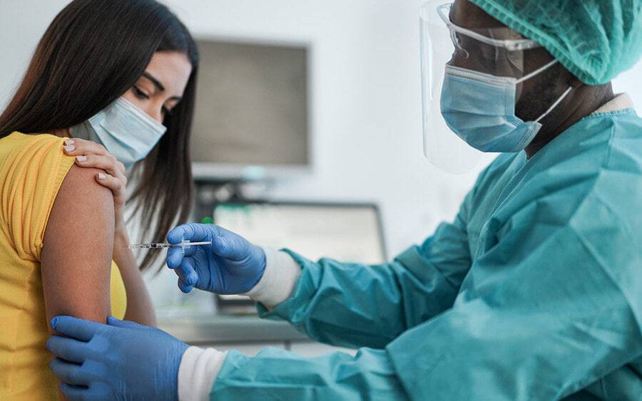 A resident giving a young patient a vaccine, representing funding for the Scripps Family Medicine Residency Program.