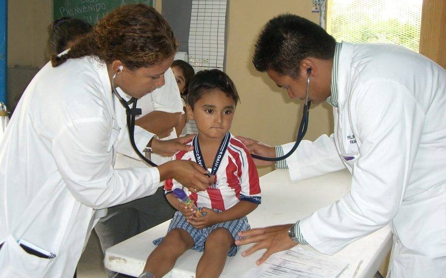 Two Scripps doctors check heart and respiratory vitals on a young boy from South County San Diego.