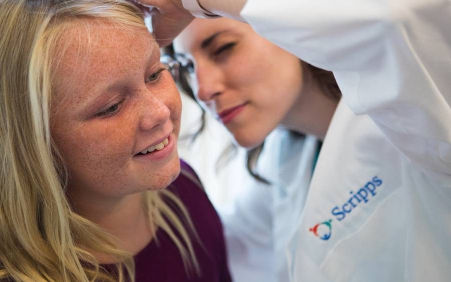 Young patient getting her ear checked by Scripps HealthExpress Carmel Valley provider