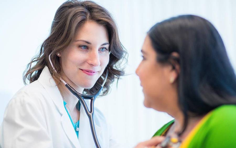 A Scripps HealthExpress provider at Solana Beach location checks on a patient.