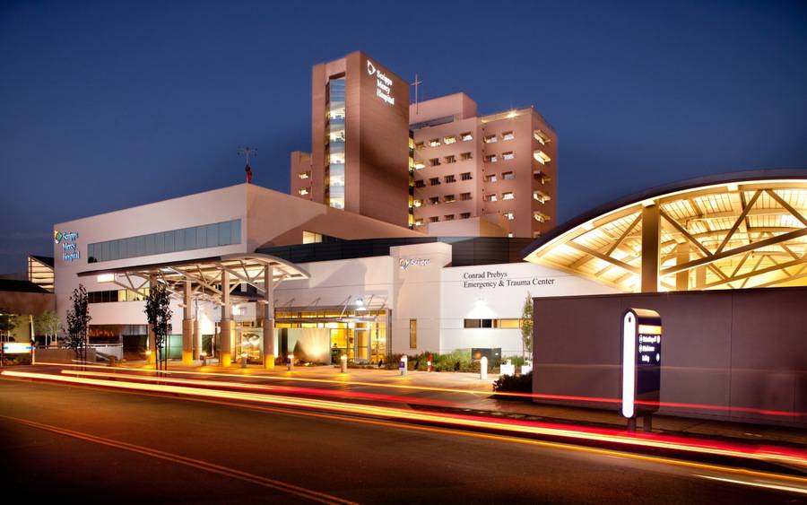 The exterior of Scripps Mercy Hopsital San Diego, lit up at night.