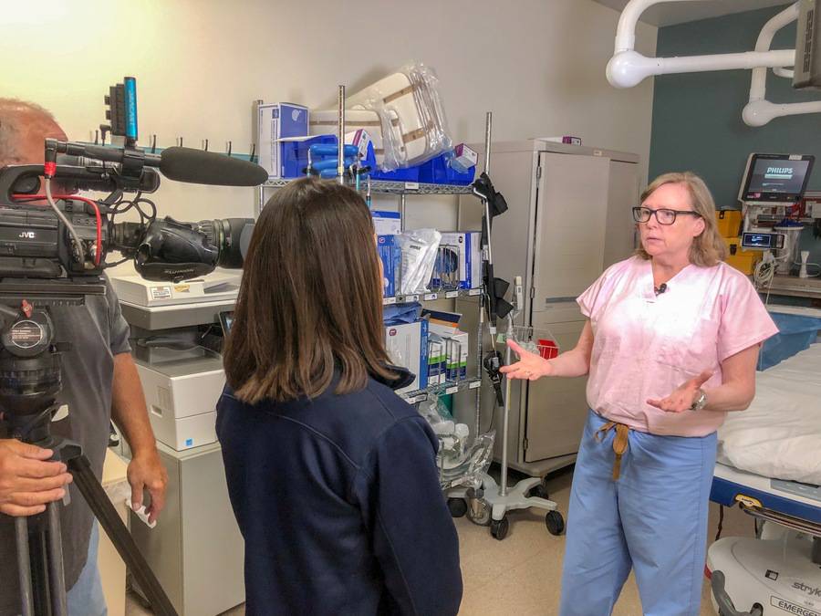 A Scripps nursing supervisor talks to a news production crew about a bill to fight hospital violence.