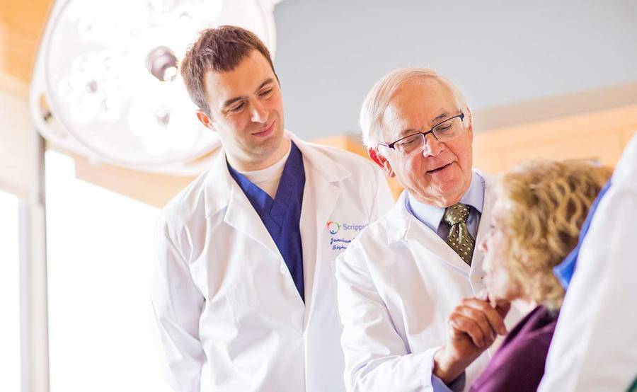 Scripps dermatologist Dr. Greenway examines a patient, representing the patient-first approach with skin cancer treatment at Scripps.