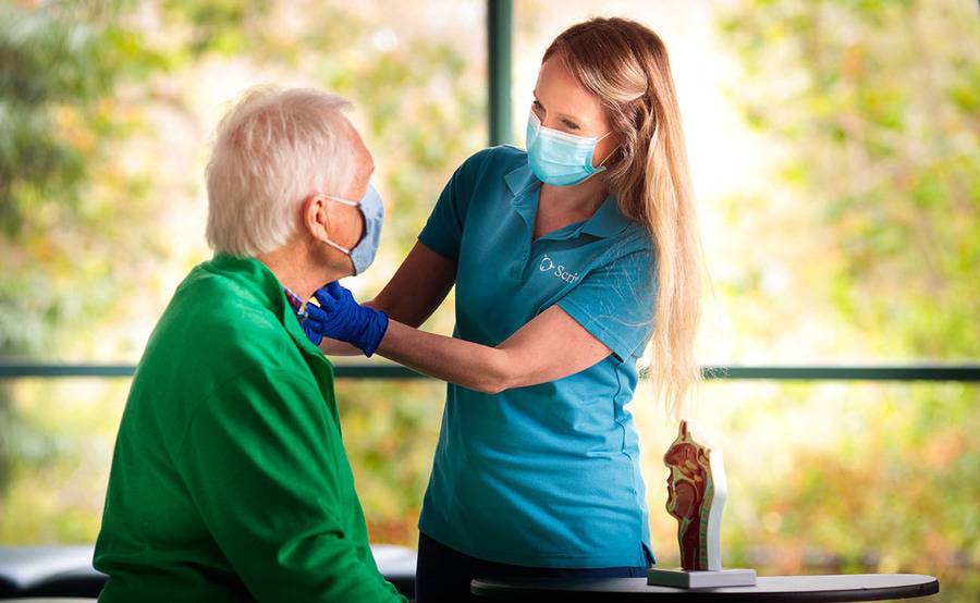 Speech therapist with patient in a speech therapy session.