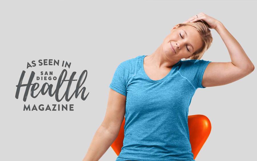 A young Caucasian woman tilts her head toward her left shoulder, demonstrating the easy stretches to prevent chronic neck and back pain.