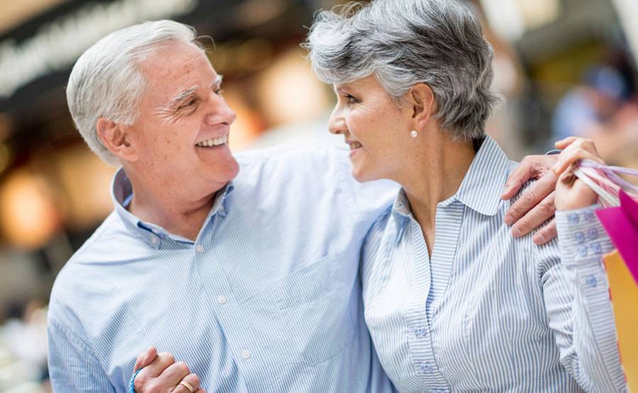 Happy mature couple shopping