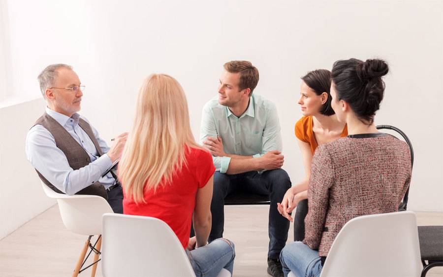 Support Group of diverse ages sitting in a circle