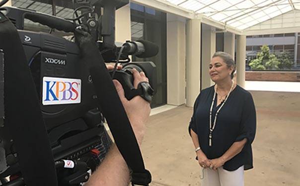 Breast cancer survivor Tarane Sondoozi talks with KPBS TV crew on a Scripps campus.