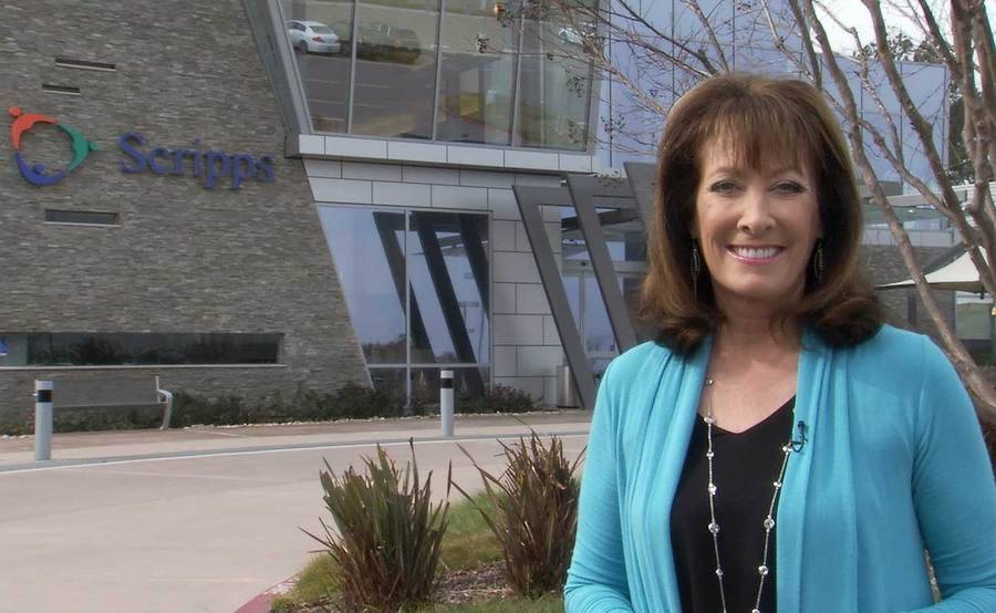 Susan Taylor honors physicians for Doctors Day, standing in front of a Scripps Health building.