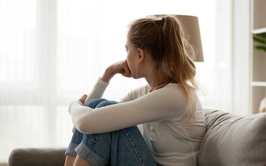 A teen-age girl looks pensive, alone at home. Could she have depression?