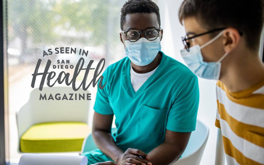 A young man talks to his doctor to be screened for testicular cancer.