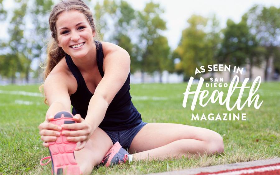 Teenage girl stretching and practicing safety tips to prevent sports-related injuries.