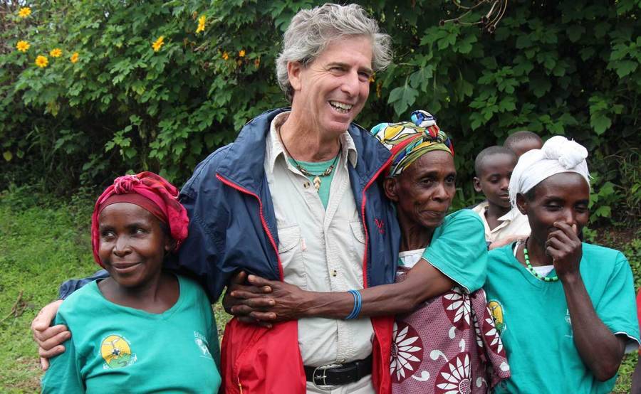 Scripps cardio patient Bill Toone stands with group of people in Africa.
