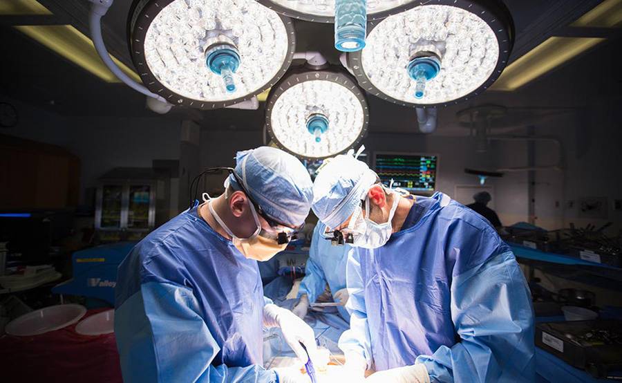 A team of transplant surgeons perform an organ transplant at in a surgery room at Scripps Health.