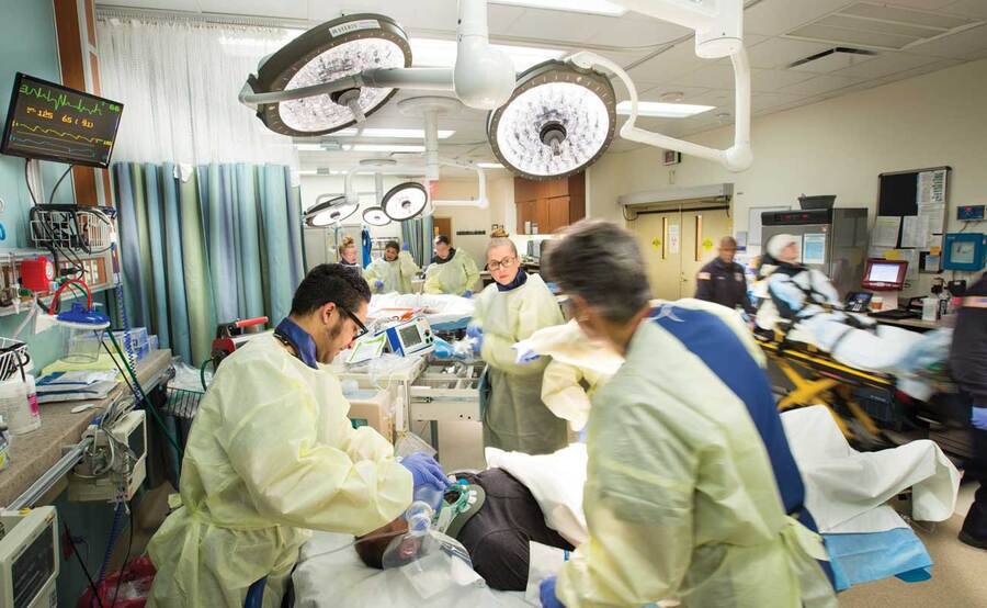 Providers in the emergency room caring for a patient who has suffered trauma.