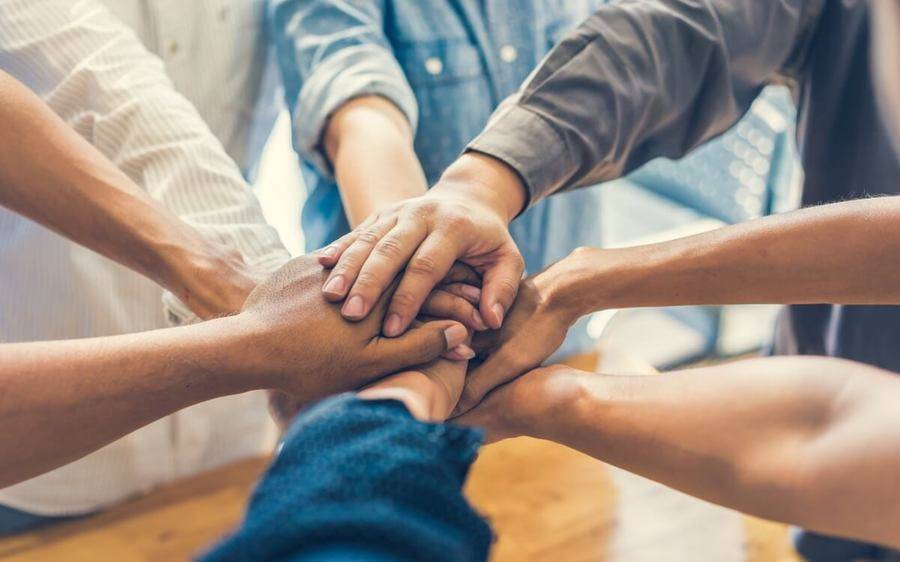 Hands join in a moment of togetherness as Scripps CEO, Chris Van Gorder, details timeless leadership advice in this blog.