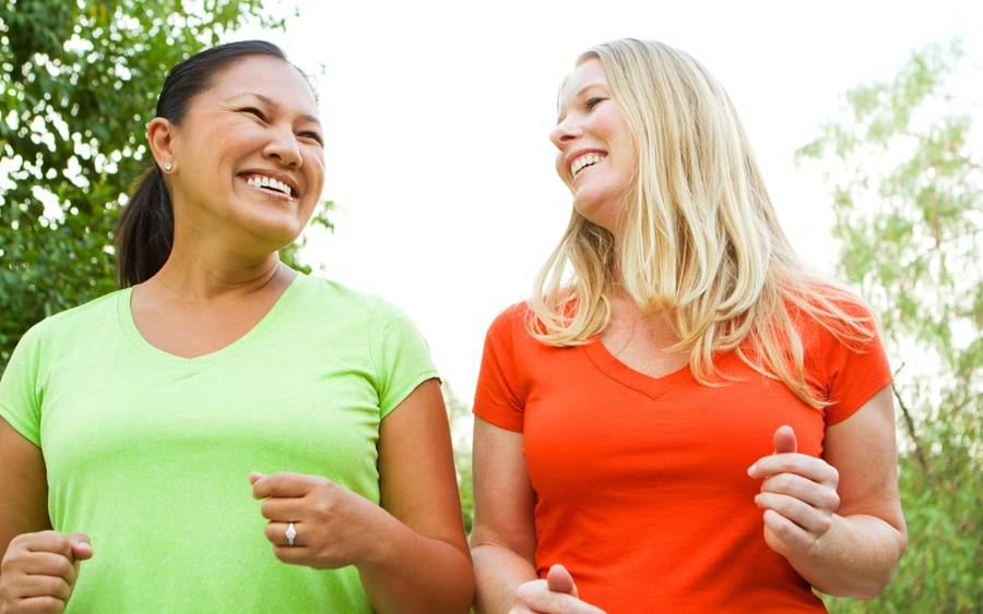 Two women enjoying a non-strenuous walk in the park.