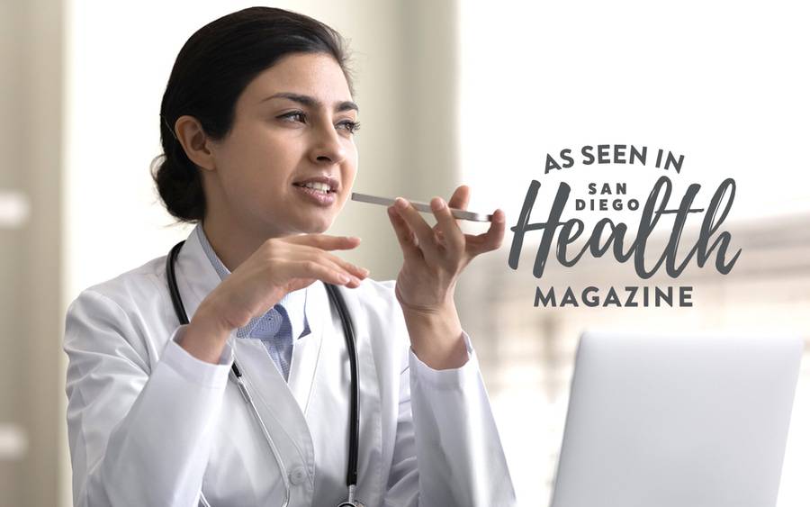 A female physician speaks into a recording device during a virtual patient visit.