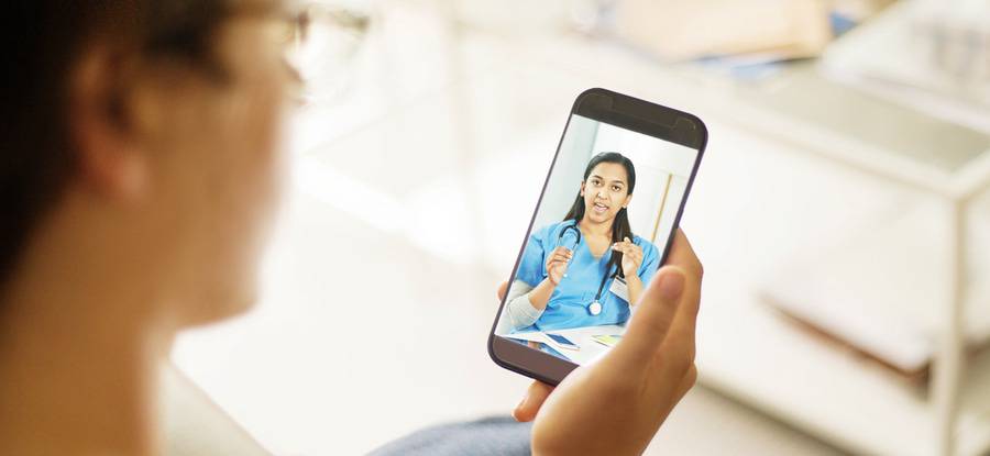 A man talks with his physician by video.