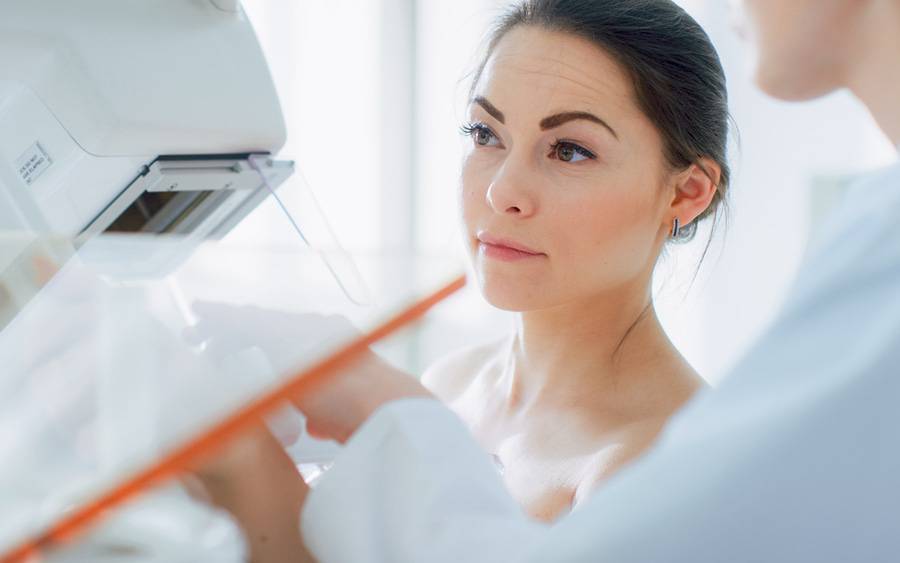 A woman undergoes a mammogram after breast surgery.