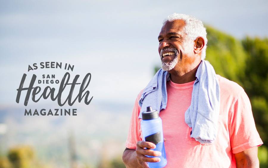 A mature man enjoys a sports drink with electrolytes after a vigorous exercise, one of five reasons to drink it over water.