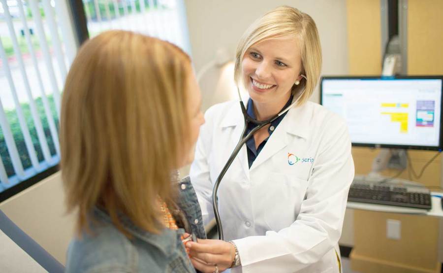 Family medicine physician Dr. Christen Benke listens to a patient's heartbeat at Scripps Clinic.