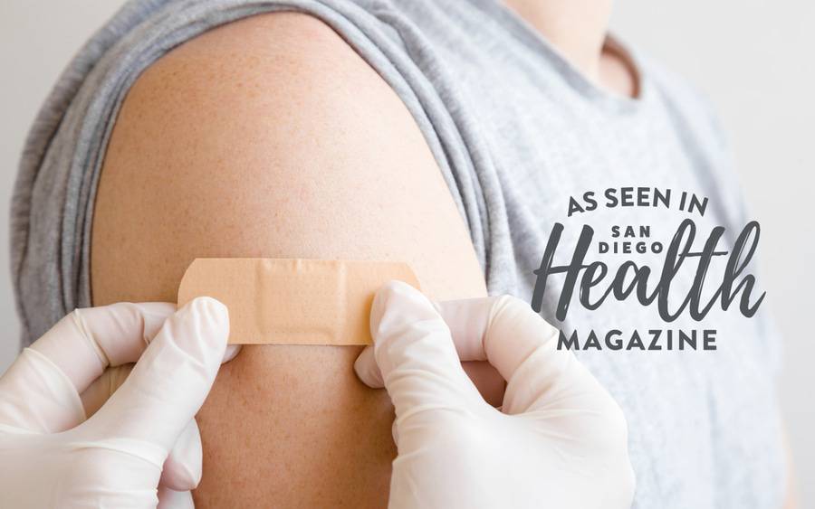 A nurse placing a bandaid after giving measles vaccination, represents the importance of vaccination after recent outbreaks.