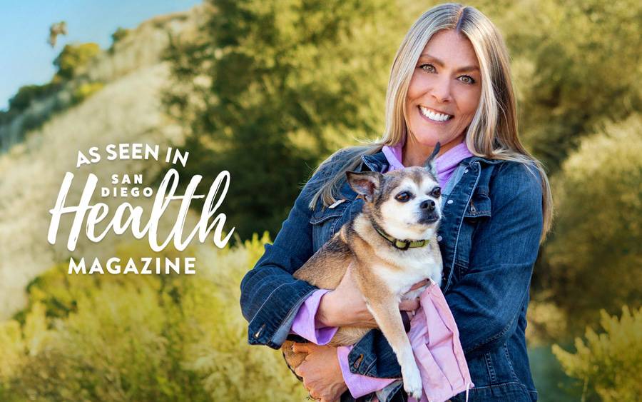 Patient Linda  MacInnes holding her dog and smiling outside