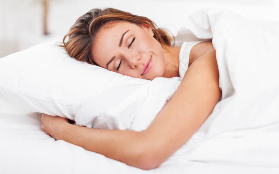 A woman practices good sleep habits and gets restful sleep.
