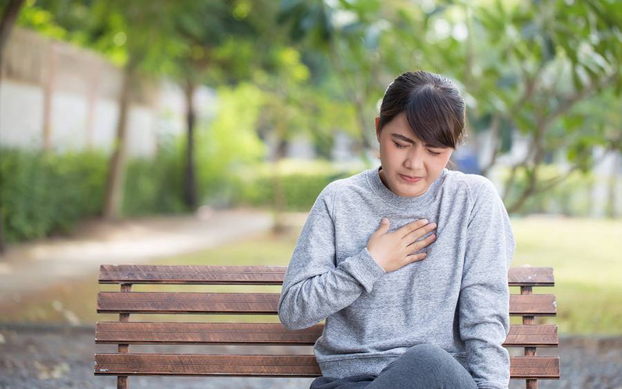 Woman experiencing heartburn. Could it be GERD?