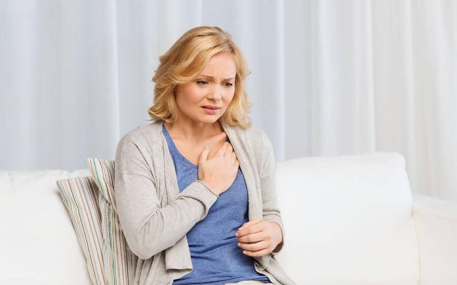 A woman experiences heart attack symptoms.