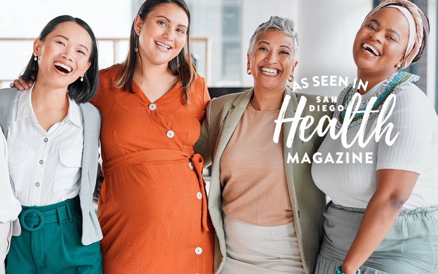 Four women of diverse backgrounds and ages smile together. SD Health Magazine