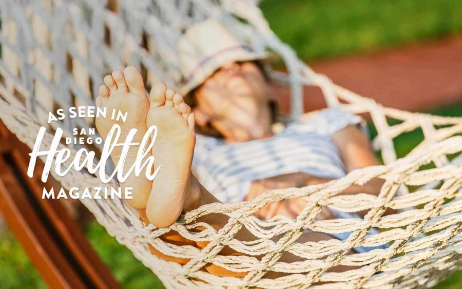 A young Caucasian woman in a hammock represents how a sedentary lifestyle can end up hurting your health.