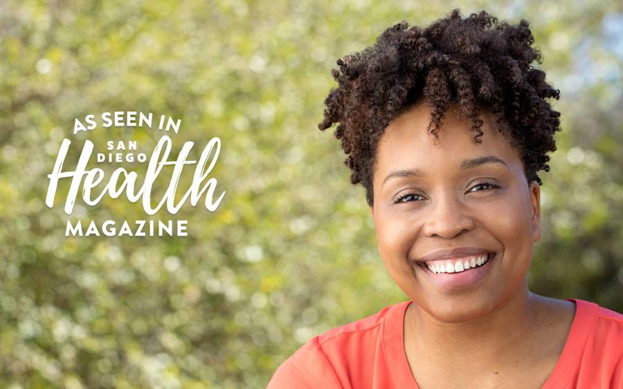 A young black woman smiles in an outdoor setting. San Diego Health Magazine