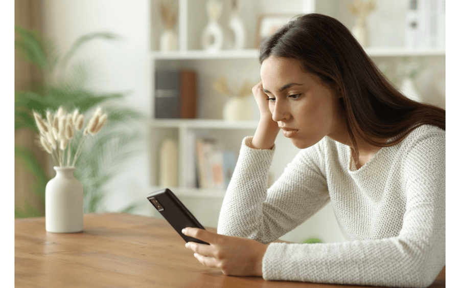 A young woman uses AI on her phone to research a health issue, risks getting misinformation.