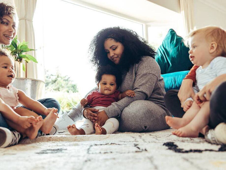 A diverse group of mom and babies participate in an exercise class designed to strengthen mom's pelvic floor after childbirth.