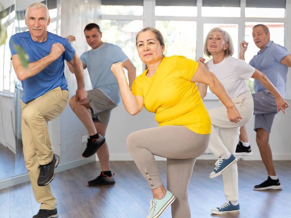 Mature adults take part in a Zumba exercise class.