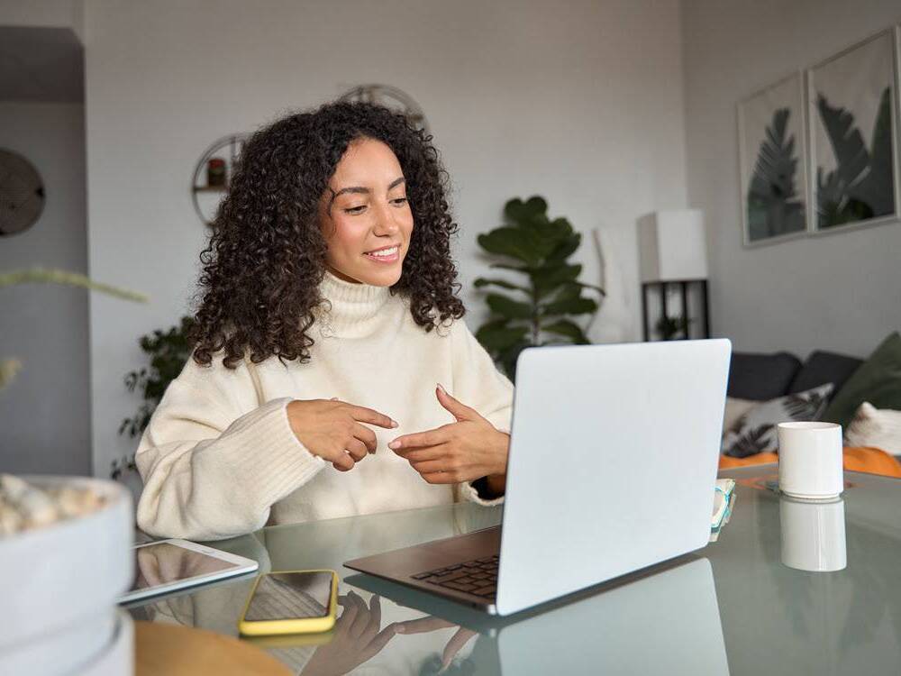 A young latino woman participates in an online discussion to learn ways to prevent chronic diseases such as diabetes and heart disease.