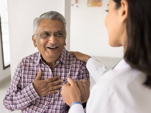 A cancer patient discusses side effects of chemotherapy with his health care provider.