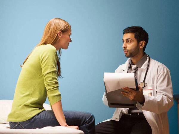 A female patient talks to her provider about treatment for an autoimmune disease.