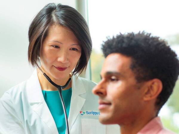 Dr. Siu Ming Geary, Internal Medicine, Scripps Clinic physician examines a patient in a clinical office. 