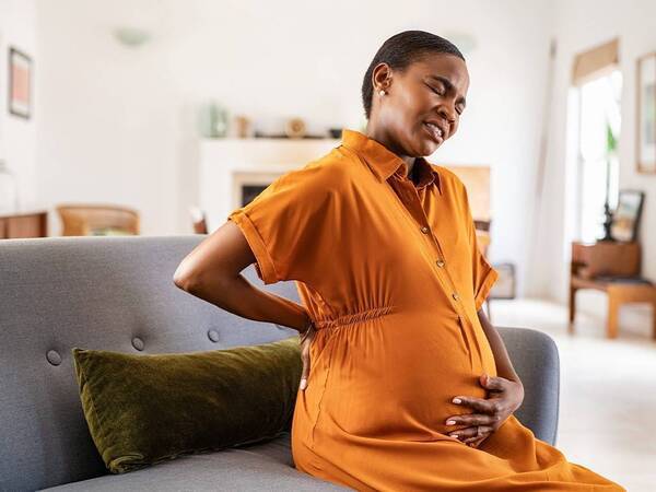 A pregnant woman experiences lower back pain.