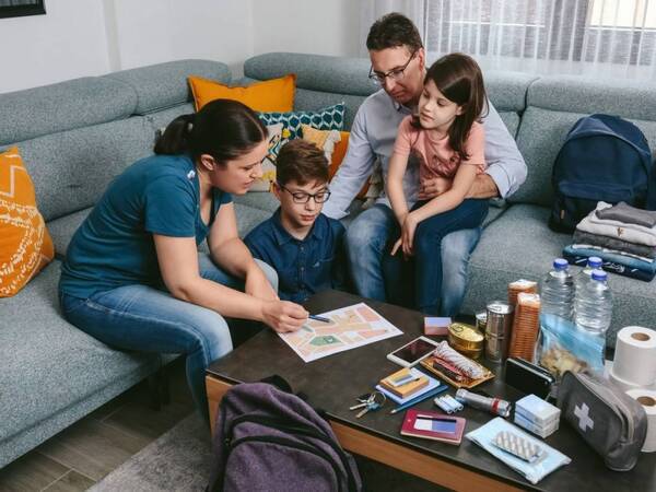 A family concerned about safety during a wildfire warning makes plans.