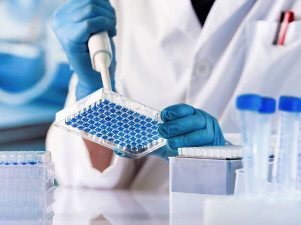 A lab worker testing for signs of genetic-related cancer.