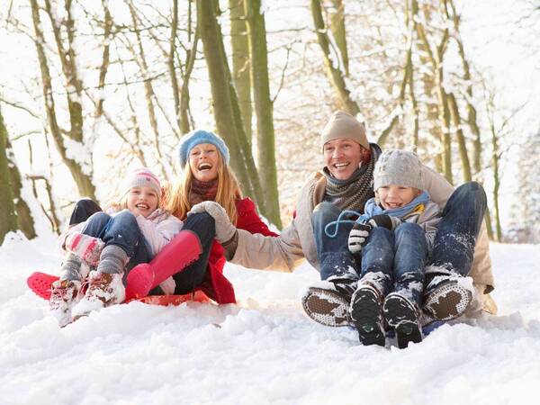 Happy people playing in the snow for holidays 