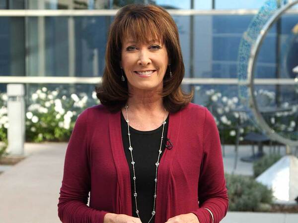 Susan Taylor standing in front of a Scripps Health location to promote Heart Month. 