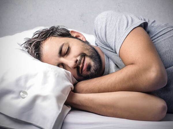 A man diagnosed with sleep apnea attempts to get a good night's sleep. 
