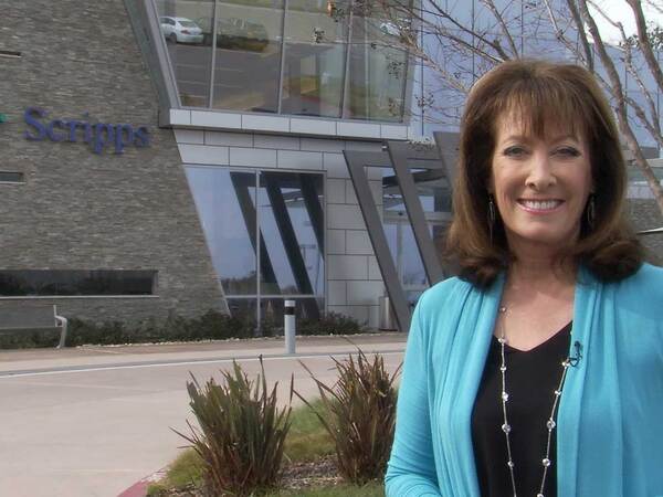 Susan Taylor honors physicians for Doctors Day, standing in front of a Scripps Health building.